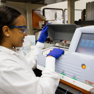 woman standing at a medical lab machine
