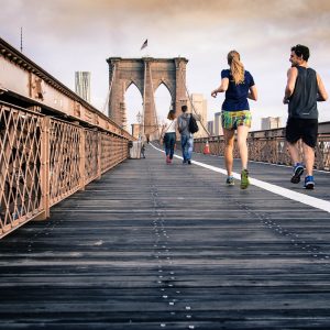 two people running on a bridge