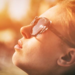 woman turning her face toward the sun