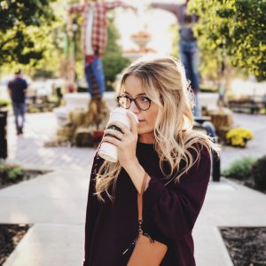 Woman drinking starbucks coffee outside