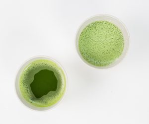 two cups of green tea on a white surface