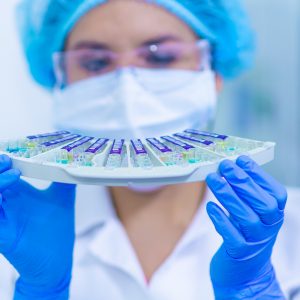 medical lab technicians holding vials