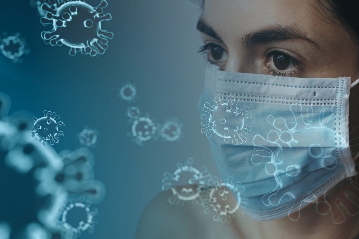 woman wearing face mask and virus molecules