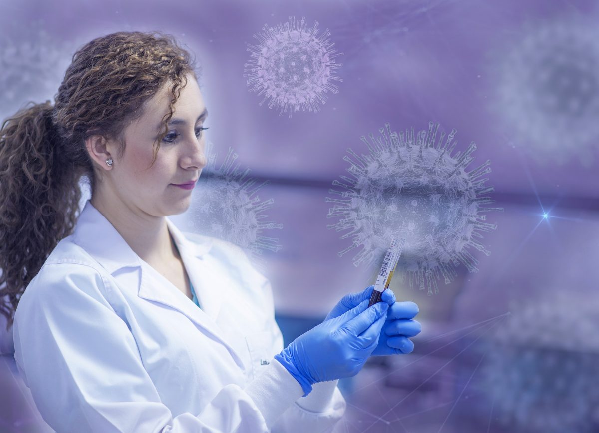 woman holding vial with virus particles