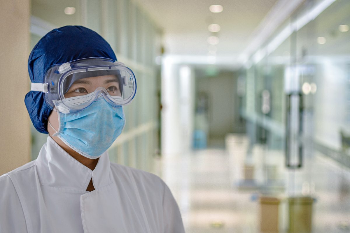 female nurse wearing goggles and mouth guard