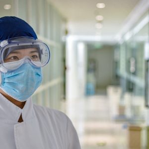female nurse wearing goggles and mouth guard