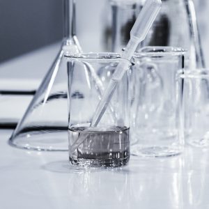 beakers, vials, glass syringes in a science lab