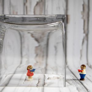 two plastic figures social distancing