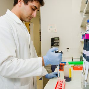 man in a lab coat working in a medical lab