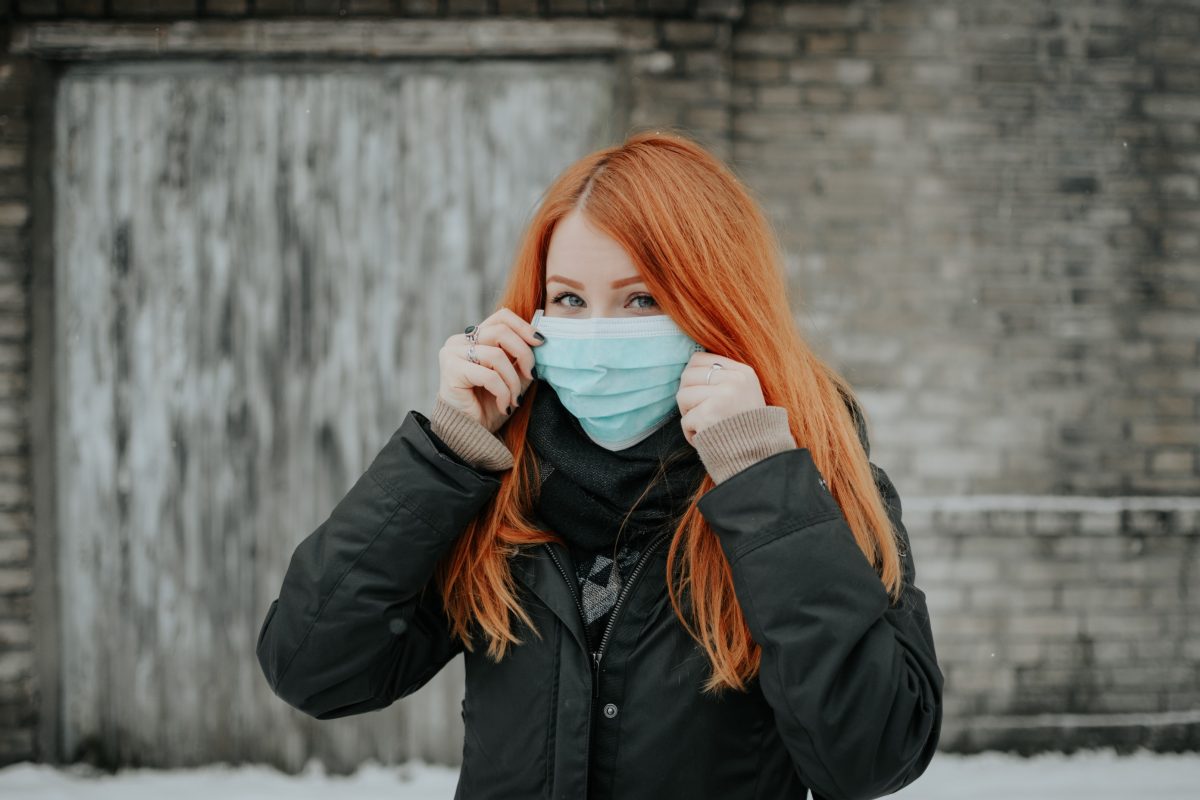 woman holding a mouth guard face mask up to her face