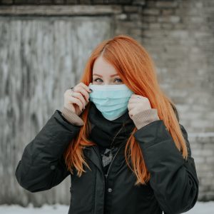 woman holding a mouth guard face mask up to her face