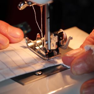person sewing a face mask