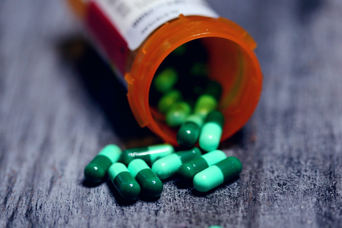 pill bottle of green pills
