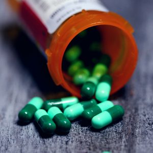 pill bottle of green pills