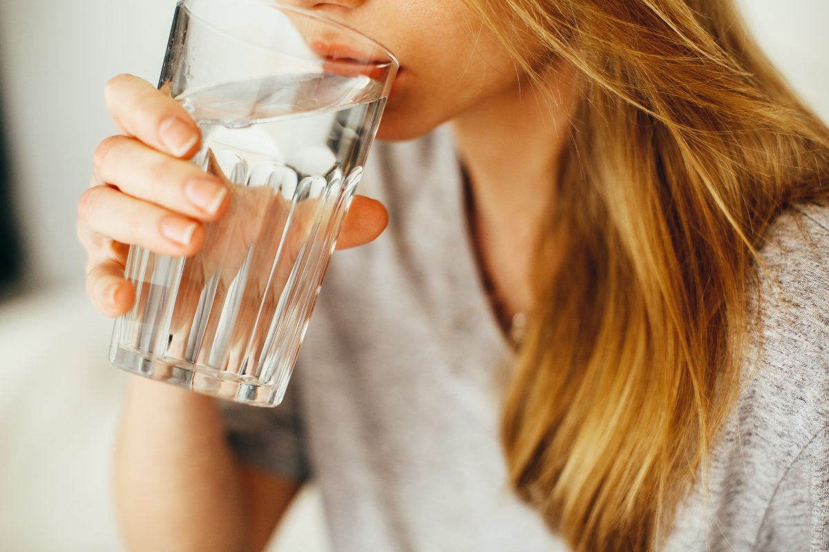 woman drinking a cup of water