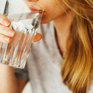 woman drinking a cup of water