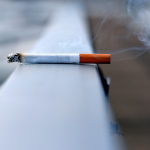 cigarette burning on a white surface