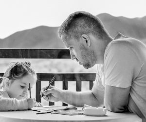 daughter and father coloring together