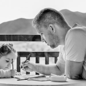 daughter and father coloring together