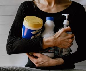 woman holding bottles of cleaner