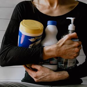 woman holding bottles of cleaner