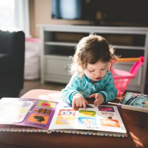 little child reading a book