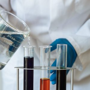 person working with lab vials