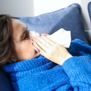 woman blowing her nose