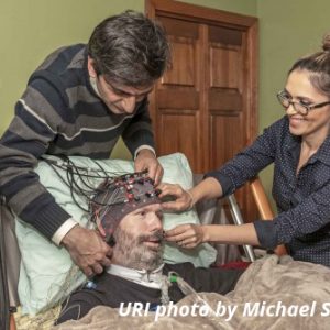 man being fitted with brain-computer interface