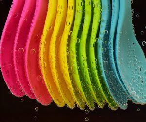 colorful plastic spoons lined up in a row