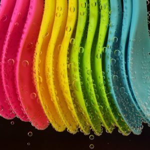 colorful plastic spoons lined up in a row