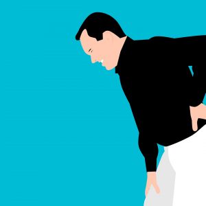 man clenching his low back in pain