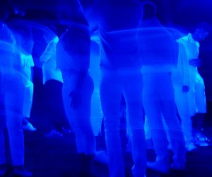 people standing in a blue light