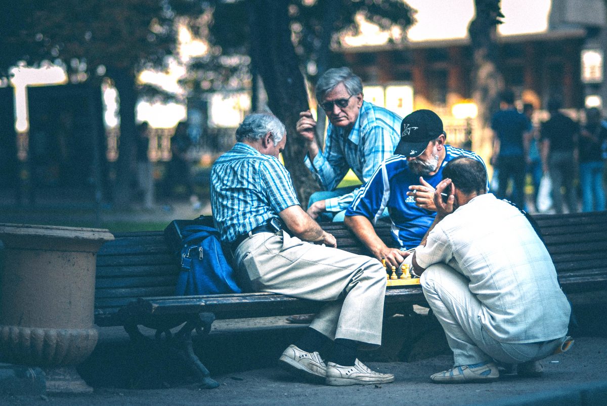 men playing chess at a park