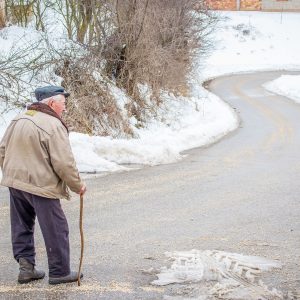 old man walking in the winter