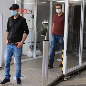 Dr. Eran Avraham, left, and Dr. Izaak Cohen from Bar-Ilan University walk through the sanitation tunnel at the entrance to Bloomfield Stadium in Tel Aviv.