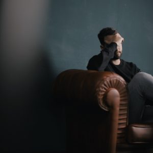 stressed out man on a couch