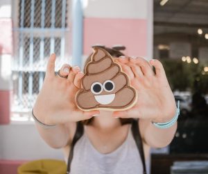 person holding the poop emoji