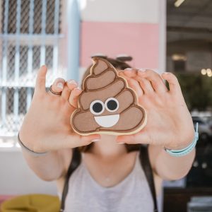 person holding the poop emoji