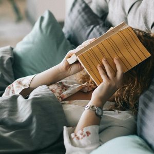 woman with a book over her face