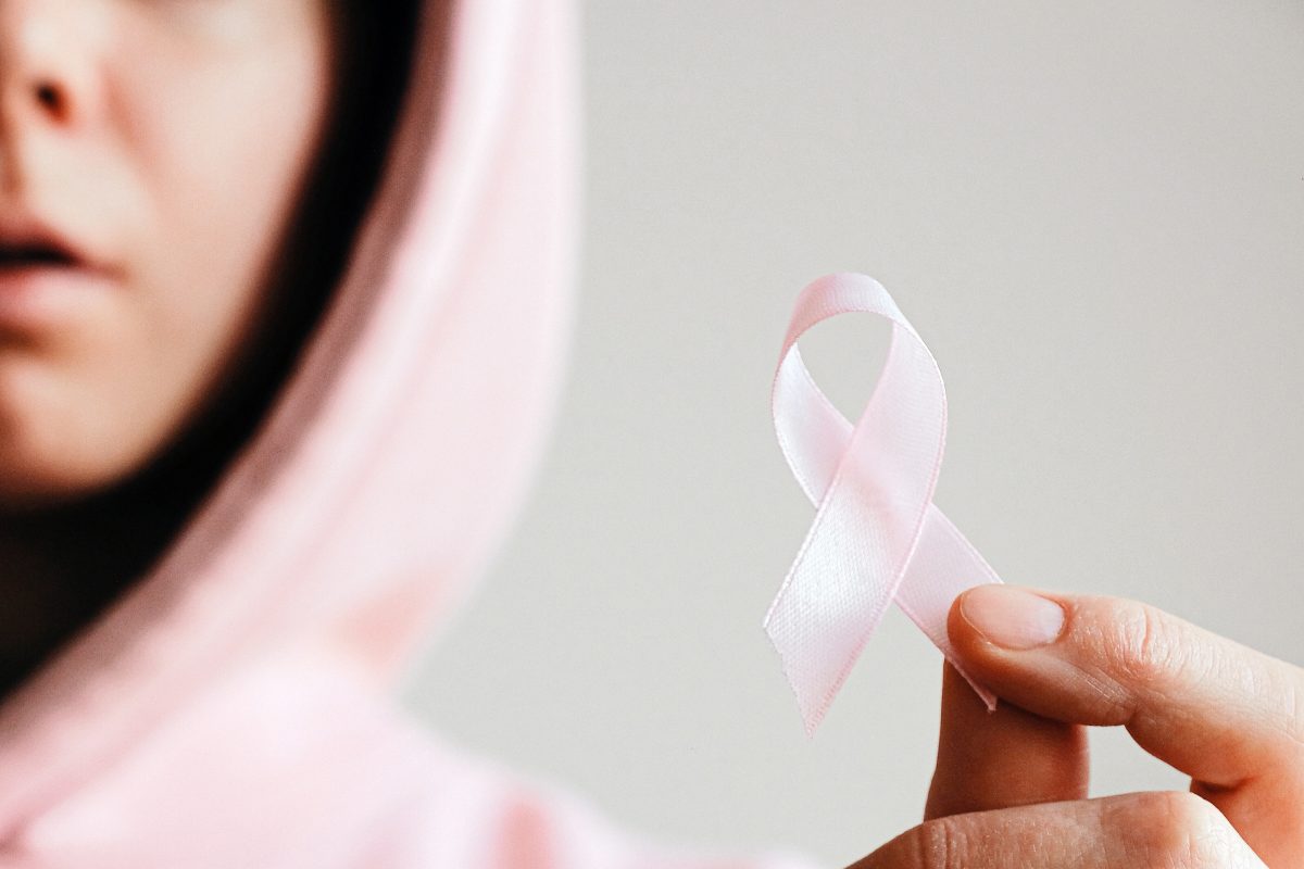 woman holding breast cancer ribbon