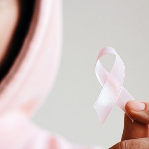 woman holding breast cancer ribbon