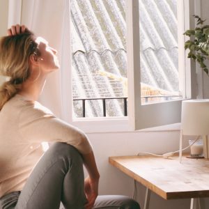 woman sitting in front of a window sunning