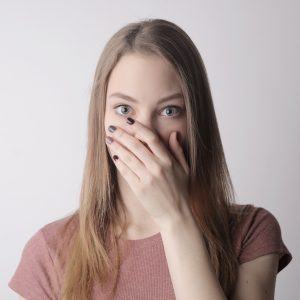 woman covering her mouth with her hands
