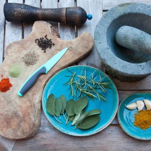 cutting board with a bunch of herbs and spices