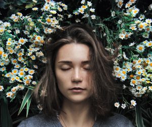 woman sleeping on a field of flowers