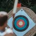 man shooting an arrow at a bullseye target