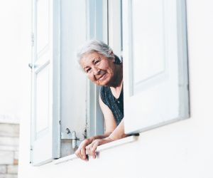 older woman looking out a window
