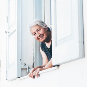 older woman looking out a window