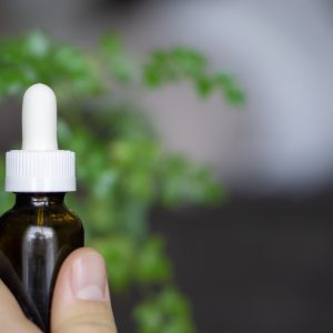 photo of person holding CBD oil